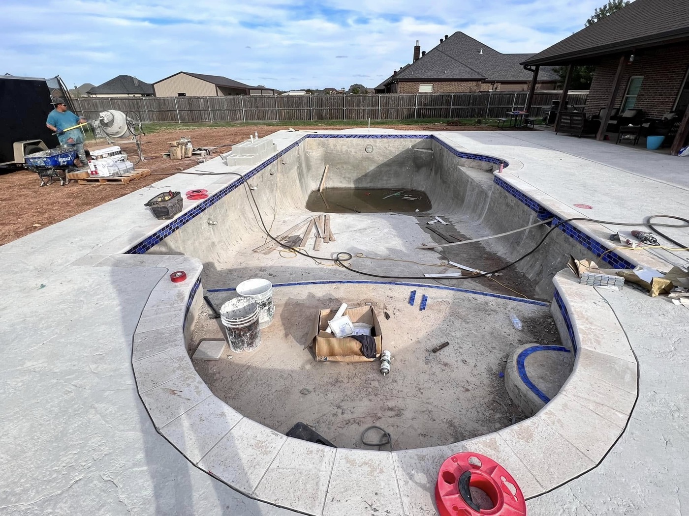 Pool shell with waterline tile installed before plaster