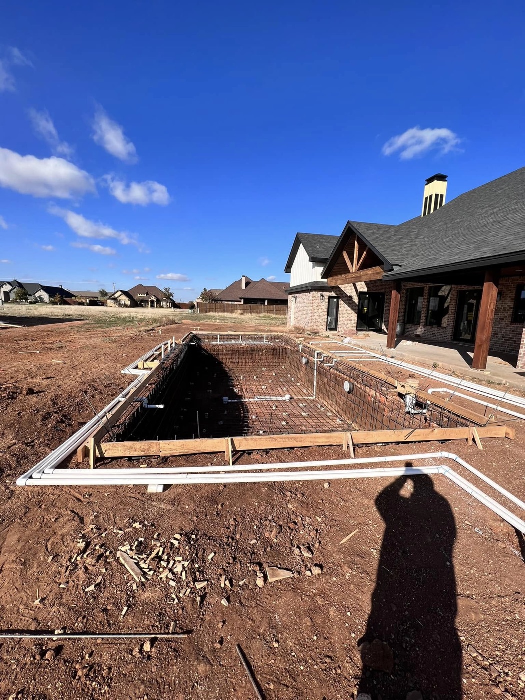 Pool shell with rebar and plumbing installed, ready for gunite